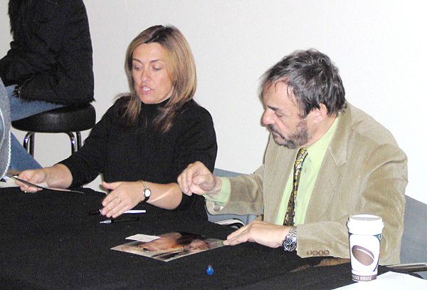 Rhys-Davies (right) signing autographs in May 2005