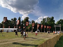 Gateway at the 2019 Kurultaj with flags representing various Hungarian runes and Pagan symbols. Kurultaj, 2019, 13.jpg