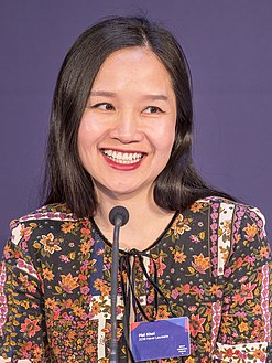 Mai Khôi smiling and looking to the side at the press conference of the 2018 Oslo Freedom Forum