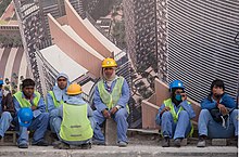 Migrant construction workers from South Asia in the West Bay area of Doha Migrant workers in West Bay Doha.jpg