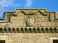 The Montgomerie family crest on the castle ruins. The Motto reads as 'Garde Bien' translating as 'Hazard Yet Forward' or 'Guard Well'.[51]