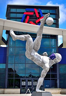 A sculpture outside the National Soccer Hall of Fame in Frisco, Texas wore a NSHOF-branded face mask during summer 2021. National Soccer Hall of Fame - Frisco TX - June 2021 - 004.jpg