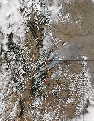This image from the Moderate Resolution Imaging Spectroradiometer (MODIS) on the Terra satellite shows (north to south) the Trinidad complex at the Colorado-New Mexico border, the Middle Ponil Complex Fire, the Bonita Fire, and the Cerro Pelado Fire. Ponil Complex Fire.jpg