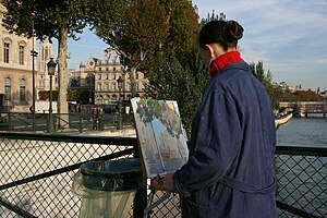 A painter on the bridge of Arts, in Paris