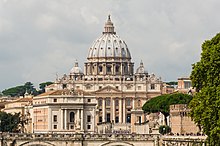 St. Peter's Basilica in Vatican City, the papal enclave within the Italian city of Rome, one of the largest religious tourism sites in the world Saint Peter's Basilica facade, Rome, Italy.jpg