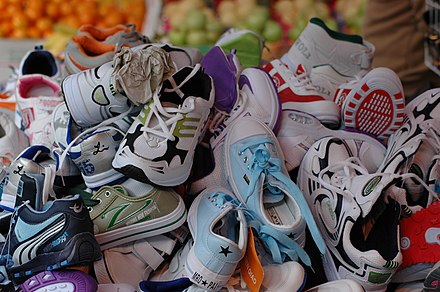 A large pile of athletic shoes for sale at a market in Hong Kong