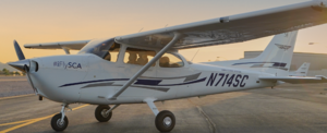 Small white plane sitting on tarmac