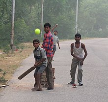 Tennis ball cricket is often played on streets Street Cricket, Uttar Pradesh, India.jpg