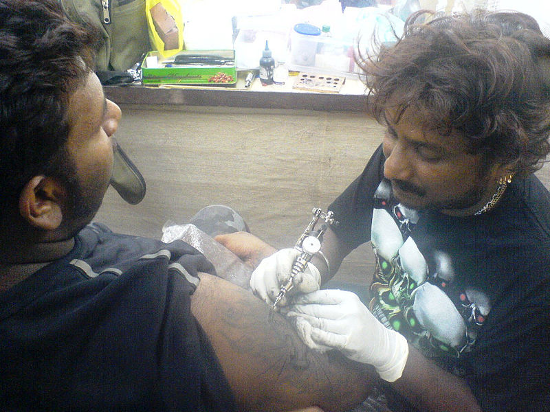 File:Tattoos, tribal-cross applying (01729).JPG