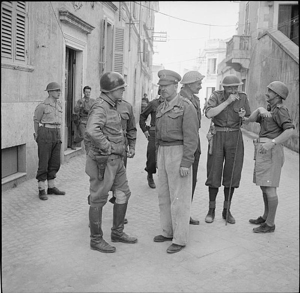 General Sir Harold Alexander with Major General Lucian Truscott and other senior Allied commanders at Anzio, Italy, 5 May 1944. Hawkesworth is picture