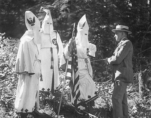Three Klansmen talking to PI reporter Robert Berman in Seattle, Washington (circa 1923). Photograph currently preserved by the Museum of History & Industry.