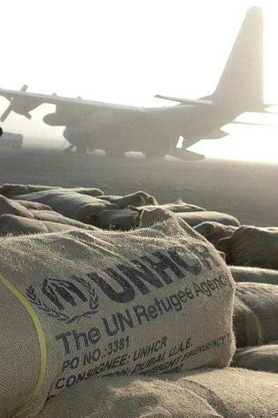 UNHCR packages containing tents, tarps, and mosquito netting sit in a field in Dadaab, Kenya, on 11 December 2006, following disastrous flooding