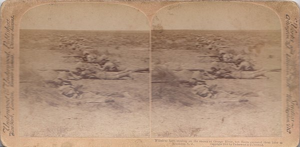Caption reads, "Wiltshire boys stealing on the enemy at Orange River, but Boers captured them later at Rensburg S.A.". Stereoscope image of the 2nd Wi