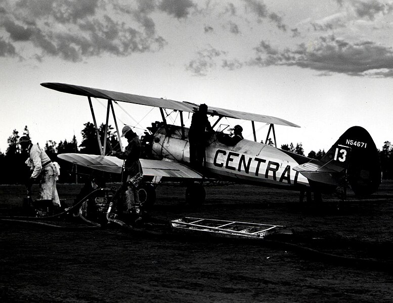 File:1955. "Gooping" a Stearman spray plane. Western spruce budworm control project. Big Summit airstrip, OR. (32213752724).jpg