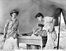 Sergeant Hosotani Naoji (left, seated) of the Kenpeitai (Japanese military police) at Sandakan is interrogated by Squadron Leader F. G. Birchall (second right) of the Missing Servicemen Section and Sergeant Mamo (right) of the Allied Translator and Interpreter Section on 26 October 1945. Naoji confessed to shooting two Australian POWs and five Chinese civilians. (Photographer: Frank Burke.) AWM 121782 sandakan.jpg