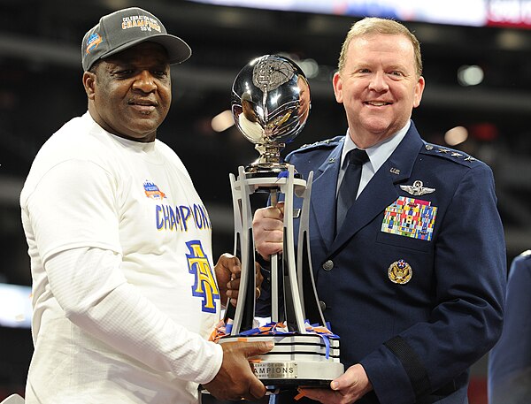 Head coach Sam Washington (left) receiving the 2018 Celebration Bowl trophy from Richard W. Scobee