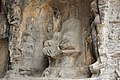 Ancient Buddhist Grottoes at Longmen- Old Dragon Grotto, Tang Dynasty, Seated Buddha Missing Head.jpg
