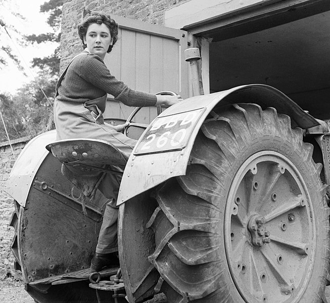 File:Anne Keys of the Women's Land Army reverses a tractor out of a shed during her training at the Northampton Institute of Agriculture near Moulton in 1942. D8823.jpg