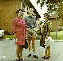Photograph of three people standing on a street