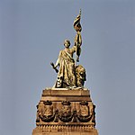 Beeld van de Nederlandse maagd, bovenop monument 1813 - 