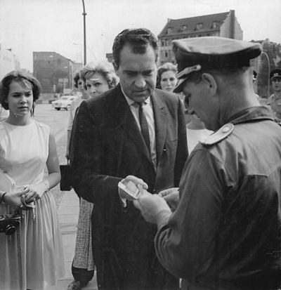 Nixon shows his papers to an East German officer to cross between the sectors of the divided City of Berlin, 1963.