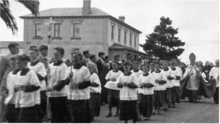 Christian Brothers' College (CBC), c. 1940s - students partaking in religious procession with Brothers' Residence in background CBC warrnambool. 1940s.png