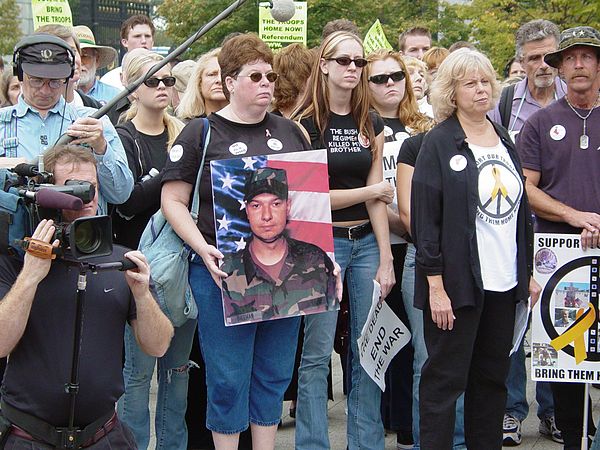 Friends and family of Cindy Sheehan hold a photo of Casey Sheehan at an anti-war demonstration in Arlington, Virginia on October 2, 2004.