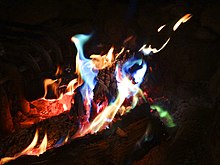 A campfire burning with blue and green flame colorants Colored Campfire - panoramio.jpg