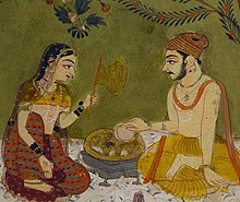 Wife serves meal to her husband. ca.1700 Detail of Kota painting, ca. 1700.jpg