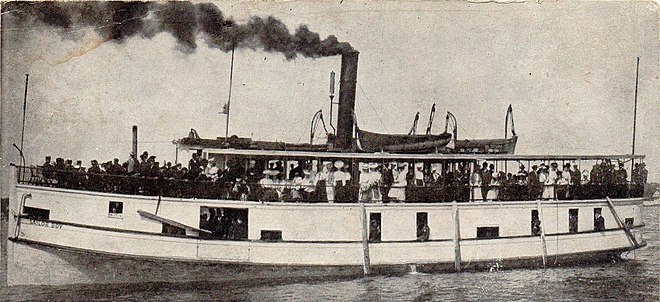 Excursion party on the Sailor Boy; postmarked 1906 in Sturgeon Bay. The Sailor Boy and other small steamboats stopped at Menominee to take on rail passengers. Since rail service was faster, tourists from Chicago would first take a northbound train in order to board steamboats bound for resort communities.[37]