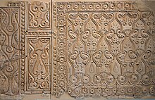 Panel of carved stucco wall decoration from Abbasid Samarra, Iraq, in the "beveled" style (9th century), showing flatter and more abstract motifs Fragment of Samarra stucco wall decoration 8361.jpg