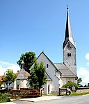 Catholic parish church Mariae Himmelfahrt and cemetery with a chapel integrated into the wall