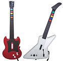 A photograph of two guitar-shaped video game controllers side-by-side, the left one red and the right one white all on a solid, white background