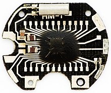The PCB of a quartz watch. The clock IC is under the drop of black epoxy. Integrovany-obvod-asfalt-.jpg
