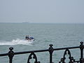 A jetskier, seen from the pier, off the Esplanade at Ryde, Isle of Wight.