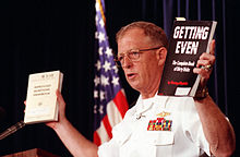 Hayduke's book Getting Even (right), held up by Rear Admiral Richard D. Milligan at a press conference concerning the 1989 USS Iowa turret explosion Milligan with books.jpg