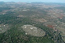 Monkodonja Bronze Age hillfort, with surroundings and coastline in the background. Monkodonja Bronze Age hillfort, Croatia.jpg