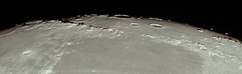 View of the limb of the Moon showing Montes Apenninus (left), Montes Caucasus (right), eastern Mare Imbrium (top), and western Mare Serenitatis (bottom), from Apollo 11. The large crater at the top center is Archimedes. Montes Apenninus Montes Caucasus AS11-44-6665HR.jpg