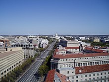 A photo of Pennsylvania Avenue NW and the red rooftops of Federal Triangle, the Internal Revenue Building addition, the U.S. Department of Justice, the National Archives (square-topped building), the rotunda belongs of the National Gallery of Art, and the U.S. Capitol in the distance OldPostOfficePennAve.jpg