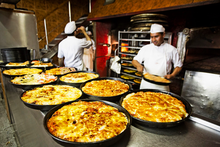 Traditional Argentine-style pizzas de molde being prepared at a pizzeria in Buenos Aires Pizzas Buenos Aires.png