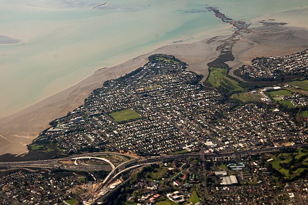 Aerial view of Point Chevalier, looking north. Meola Reef visible top right, construction of Waterview Connection at bottom left