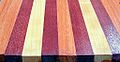 A board laminated with Purpleheart (the darkest of the three), as well as the lighter colored cherry and the salmon colored Lyptus.