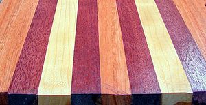 A board laminated with purpleheart (the darkest wood), cherry (the lightest wood), and Lyptus, the salmon colored wood. Purpleheart-Lyptus-Cherrywoods.jpg