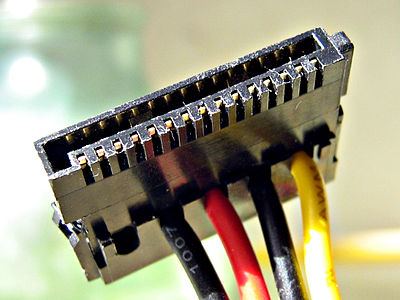 A fifteen-pin SATA power connector (this particular connector is missing the orange 3.3 V wire)