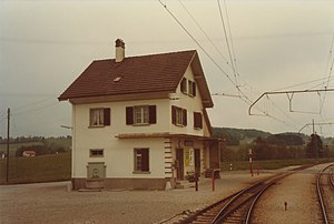 Three-story building next to a railway track