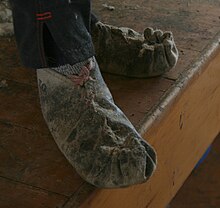 Shearers wear moccasins to protect their feet, grip wooden floors well, and absorb sweat. ShearersMoccasinsC2289.jpg