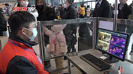 Fail:Staff monitoring passengers' body temperature in Wuhan railway station during the Wuhan coronavirus outbreak.jpg