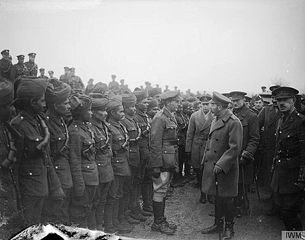 King George V inspecting Sikh and Rajputs troops attached to the Royal Garrison Artillery at Le Cateau, 2 December 1918.