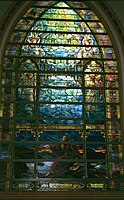 The Holy City by Louis Comfort Tiffany (1905). This 58-panel window has brilliant red, orange, and yellow etched glass for the sunrise, with textured glass used to create the effect of moving water.