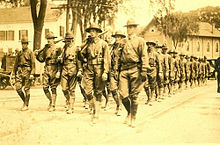 Troops marching through town c. 1918